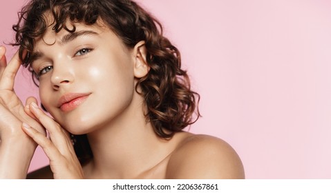 Skin care and beauty. Close up of smiling girl, glowing face after nourishing gel, facial cream, pink background.