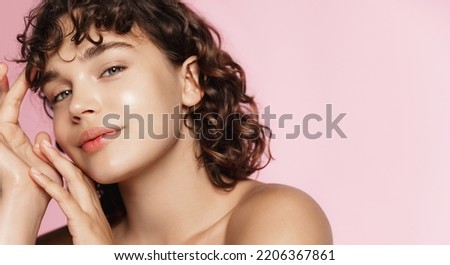 Skin care and beauty. Close up of smiling girl, glowing face after nourishing gel, facial cream, pink background.