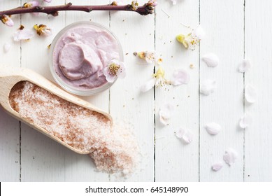 skin care creams and himalayan salt on scoop, peach flower twigs on white wooden table - Powered by Shutterstock