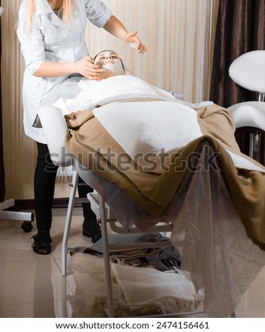 Similar – Image, Stock Photo Caregiver helping elderly female patient to get out of bed