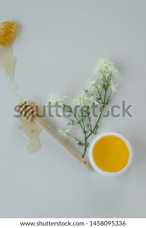 Similar – Image, Stock Photo Honey flows from glass and flowers