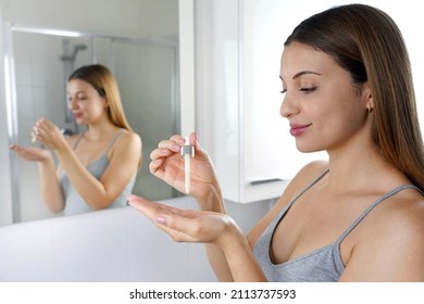 Skin Care Routine. Beautiful Woman Holding A Pipette In Her Hand With Serum Moisturizing Anti Aging Antioxidant.