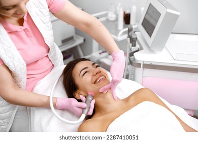 Skin care service,Cosmetology service,Cosmetic procedure,Healthy skin,Hydro-dermabrasion,Rejuvenation treatment,cosmetology procedure. cosmetologist is performing a skincare treatment on a woman - Shutterstock ID 2287410051
