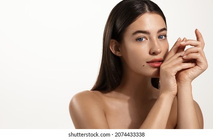 Skin Care And Spa. Young Woman With Healthy Hair And Glowing Body Skin, Touching Her Face Without Makeup, Concept Of Skincare Cleansing Products, White Background