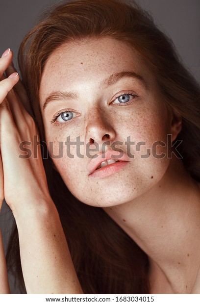 Skin care. Woman with beautiful freckles and\
healthy hydrated skin. Sensitive girl model with natural makeup.\
High quality image