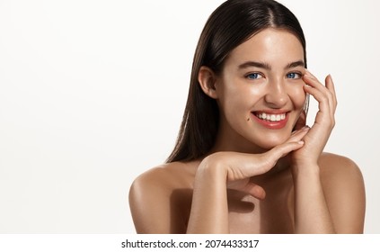 Skin Care. Woman With Beauty Face Touching Healthy Facial Skin Portrait. Beautiful Smiling Girl Model With Natural Makeup Touching Glowing Hydrated Skin On White Background Closeup