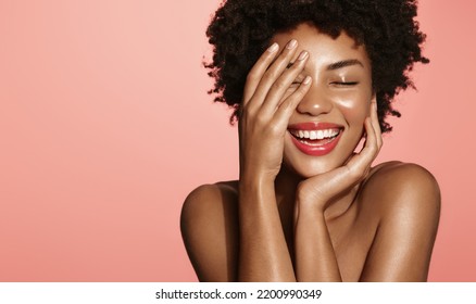 Skin Care. Woman With Beauty Face Touching Healthy Facial Skin Portrait. Beautiful African Girl Model With Natural Makeup Touching Glowing Hydrated Skin On Pink Background Closeup