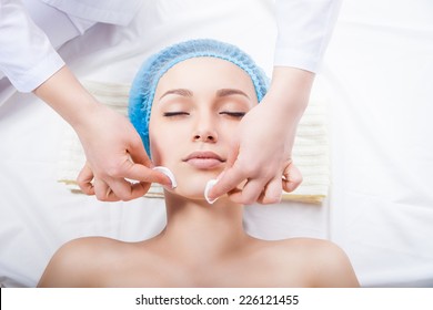 Skin Care - Woman Cleaning Face By Beautician Over White Background