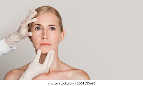 Skin Check. Close Up Of Hands In Gloves Touching Middle-aged Woman's Face, Dermatologist Examining Condition, Copyspace