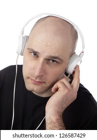 Skin Head Guy With Cleft Chin Listening Music On His Headphone