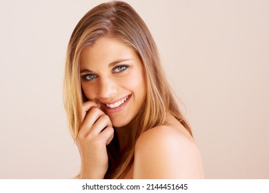 Skin So Luminous.... Sideways Portrait Of An Attractive Young Woman Smiling At The Camera.