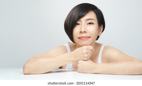 Skin radiance concept. Portrait of a beautiful 30s asian woman in white inner wear with flawless face, shiny healthy hair. K-beauty, Collagen, Products, Clinic, Plastic surgery, V shape, Skincare, 40s