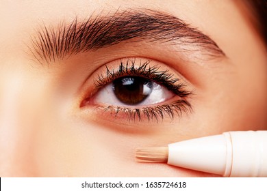 Skin Tone. Eye Corrector. Natural Make Up For Eyes Close Up. Model Face Of Beautiful Woman With Foundation On Skin Make-up Cosmetics. Perfect Skin Tone. Apply Concealer And Cosmetic Highlighter