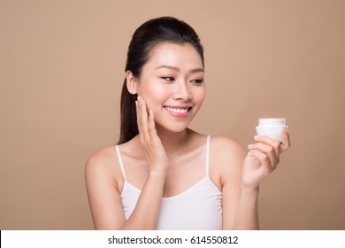 Skincare. Beautiful Asian Woman Show Moisturizer Or Lotion Product.