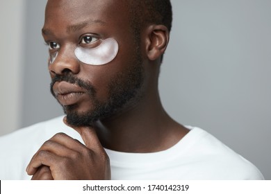 Skincare Beauty Routine. Black Under Eye Patches On Male Model. Cosmetic Mask On Face. Cosmetology Facial Treatment.