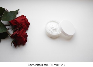 Skincare beauty treatment plant-based products with red rose petals. Jar of body or face moisturizer, homemade cosmetic ingredients on white background. - Powered by Shutterstock