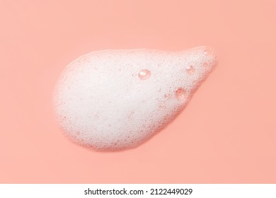 Skincare cleanser foam texture. Soap, shampoo, cleansing mousse bubbles swatch on pink color background. Face wash lather closeup - Shutterstock ID 2122449029