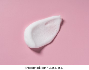 Skincare cleanser foam texture. Swatches of soap, shampoo and cleansing mousse foam with copy space on pink background. Close-up of facial cleansing soap.