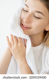 Skincare Cleansing. Morning Treatment. Hygiene Wellness. Satisfied Calm Woman Drying Fresh Radiant Face Skin With Towel On White Background.