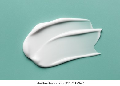 Skincare cosmetic cream lotion swatch smear smudge on mint color background. White creamy hygiene beauty product close up - Powered by Shutterstock