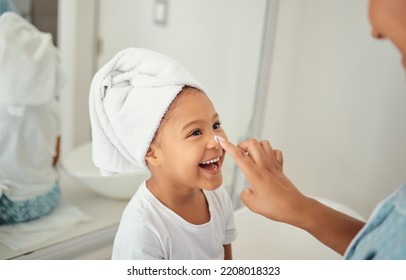 Skincare, cream and girl child at home with mother with a happy smile in a bathroom. Happiness of a kid and mom using face lotion, skin wellness and youth morning beauty routine at a family house - Powered by Shutterstock