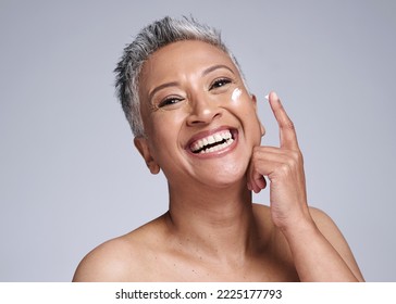 Skincare, cream or happy senior woman, healthy skin or smile for beauty product on face against grey studio background. Elderly latino model happiness, cosmetic wellness and sunscreen for body health - Powered by Shutterstock