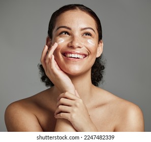 Skincare, face beauty and woman with cream for acne, dermatology and glow on a studio background. Spa, sunscreen and model thinking of a cosmetics product for dermatology and facial wellness - Powered by Shutterstock