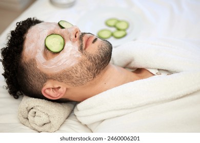 Skincare, face mask and man in spa with cucumber for vegan beauty, skin glow and dermatology therapy. Male client, facial cream and acne detox in salon for self care, anti aging and luxury aesthetic - Powered by Shutterstock