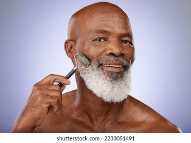 Skincare, face roller and old man facial massage with gua sha stone for glowing healthy skin. Wellness, dermatology and relax, portrait of black man with jade roller for anti aging routine in studio.