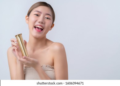 Skincare And Makeup Concept Beautiful Asian Female Woman With Healthy Facial Skin Close Up Portrait Studio Shot Hand Hold Serum Pr Cream Package With Happiness And Joyful