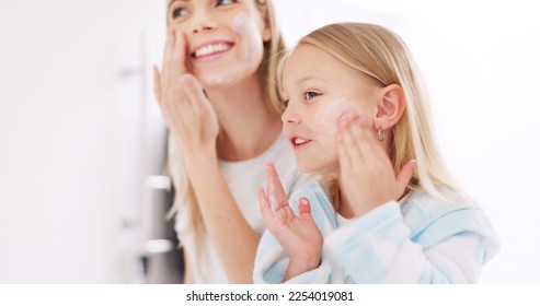 Skincare, mother and daughter home spa day washing their face in bathroom or apply beauty product, lotion or face mask while bonding at home. Happy woman and girl child doing morning skin routine - Powered by Shutterstock