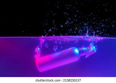 Skincare Product Bottle Falling Into Water Against Black Background In Neon Light