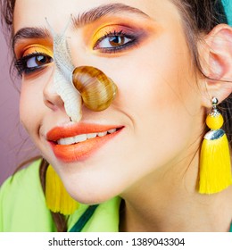 Skincare repairing. Healing mucus. Having fun with adorable snail. Cosmetics and snail mucus. Cosmetology beauty procedure. Girl fashionable makeup face and cute snail. Skin care. Massage with snail.