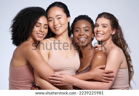 Skincare, support and diversity of women with a hug for makeup collaboration, cosmetics and beauty on a studio background. Affection, happy and portrait of model friends with cosmetic empowerment