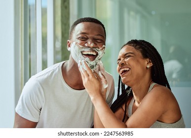 Skincare wellness, happy couple in bathroom and shaving face with product for facial treatment. Laughing together in home, natural beauty and funny girlfriend helping black man with cream application - Powered by Shutterstock