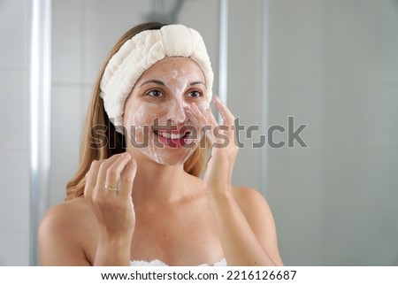 Skincare woman washing face foaming soap scrubbing skin. Face wash exfoliation scrub soap woman washing scrubbing with skincare cleansing product. Enjoying relaxing time.