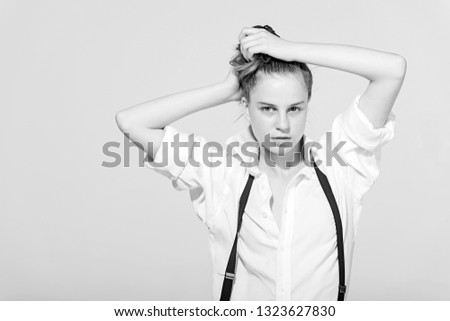 Skincare, youth and look. Makeup, hairdresser and cosmetics. Beauty and fashion, cosmetics. Woman with stylish hair and natural makeup, retro. Girl in fashionable pants, suspenders and shirt.