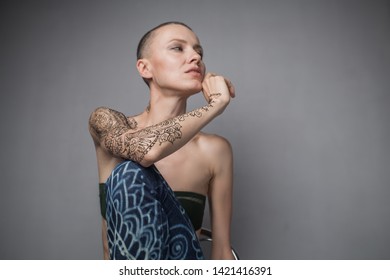 Skinhead Woman Portrait With Mehendi On An Arm And Jeans