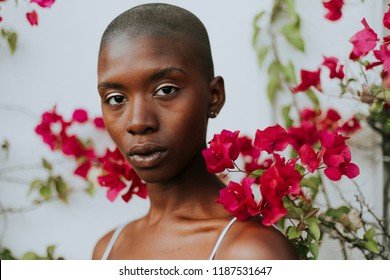 Skinhead Woman Surrounded By Red Flowers