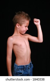 Skinny First Grader Showing His Muscles