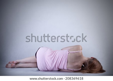Skinny girl lying on the floor, horizontal