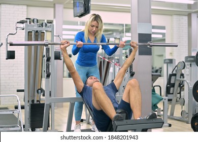 Skinny Guy Does Bench Press Under The Supervision Of A Trainer, Closeup