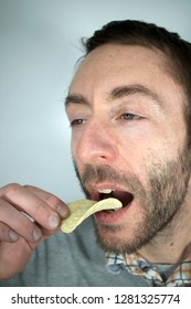 Skinny Man Eating Unhealthy Potato Chips