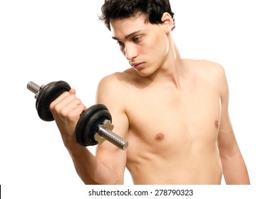 Skinny Man Training His Bicep Muscle. Beautiful Teenager Lifting A Dumbbell.Anorexic Young Man Training To Become Stronger