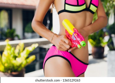 Skinny Slim Sexy Figure Of Woman Playing With Watergun Toy At Pool On Summer Tropical Vacation On Villa Hotel Having Fun In Bikini Swimsuit, Colorful Style, Party Mood