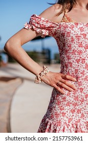 Skinny Woman Arm Leaning Hand On Her Waist, She Wears A Summer Dress And A Hair Tie