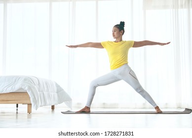 Skinny woman wear yellow sport t-shirt practice yoga exercises for relaxing in the bedroom , healthy concept