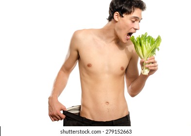 Skinny Young Man Eating An Organic Healthy Salad And Dieting. Green Food For A Healthy Life And A Perfect Diet