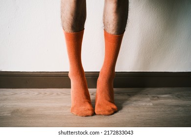 Skiny Man Wearing Orange Socks Stand Still With Medium Low Angle Shot