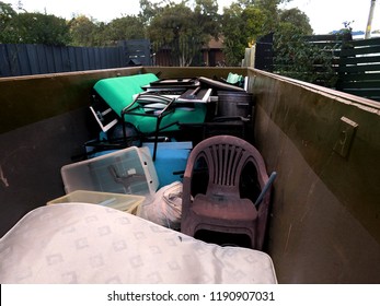 skip bin full of waste in a front yard